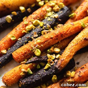 Vibrant Roasted Carrots with Pistachio Crunch 5 rainbow carrots sprinkles with pistachio nuts close up