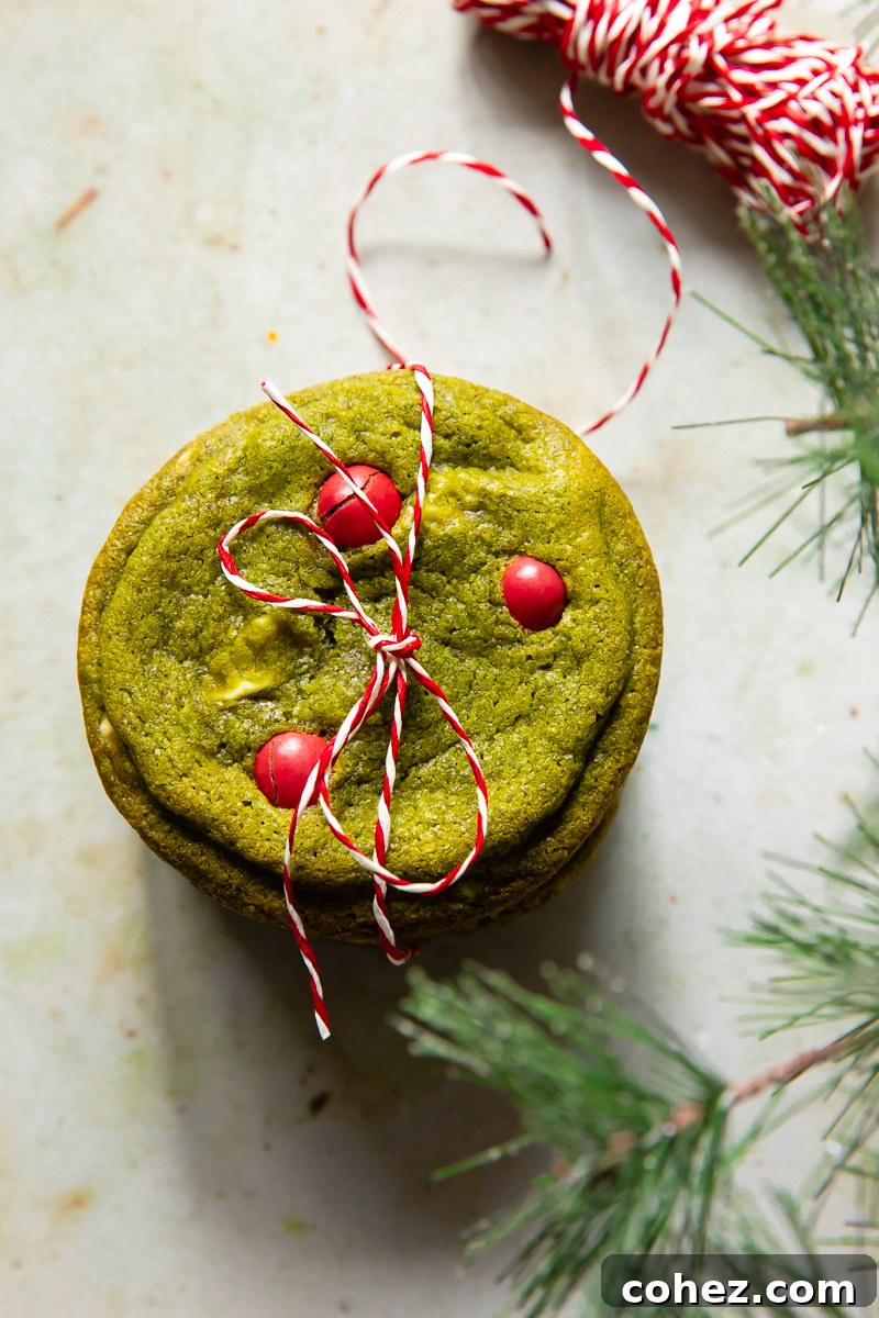 Top-down view of a stack of matcha cookies tied with a red and white baker's twine