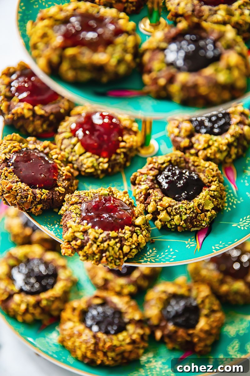 Chocolate-Filled Thumbprint Delights 2 thumbprint cookies on a green tiered plate