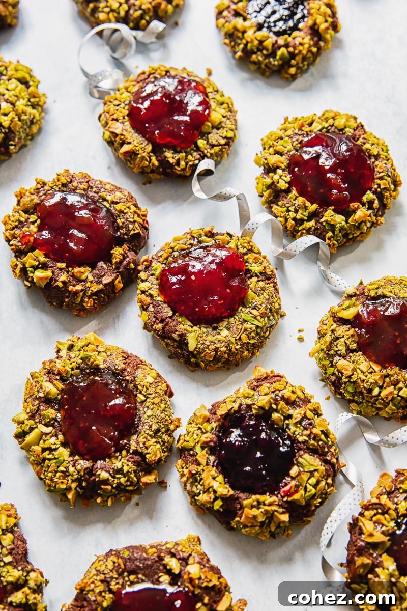 Chocolate-Filled Thumbprint Delights 3 top down view of Christmas cookies filled with jam