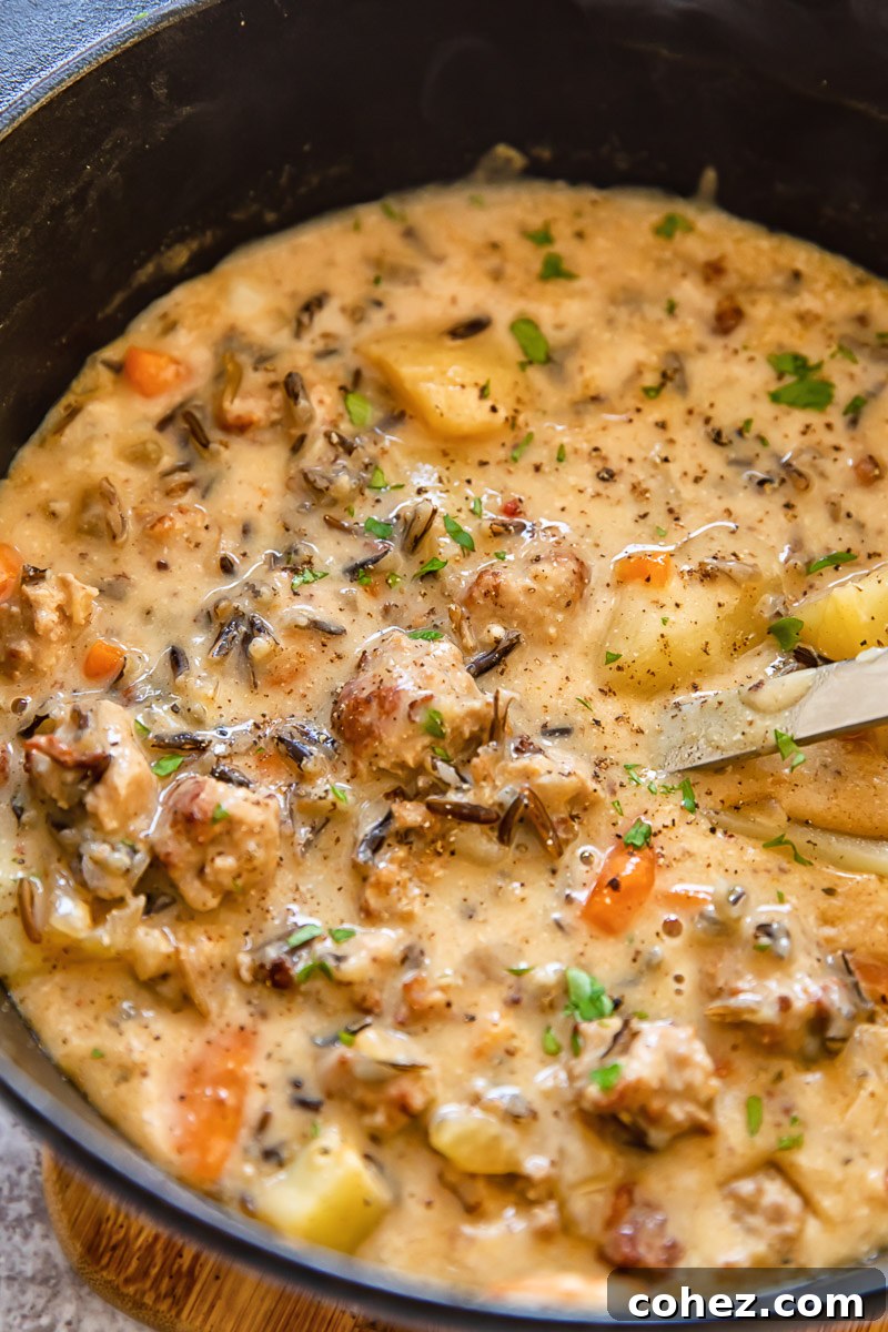 Farmhouse Sausage Potato Chowder 3 An overhead shot of a large pot filled with rich, simmering potato and sausage chowder.