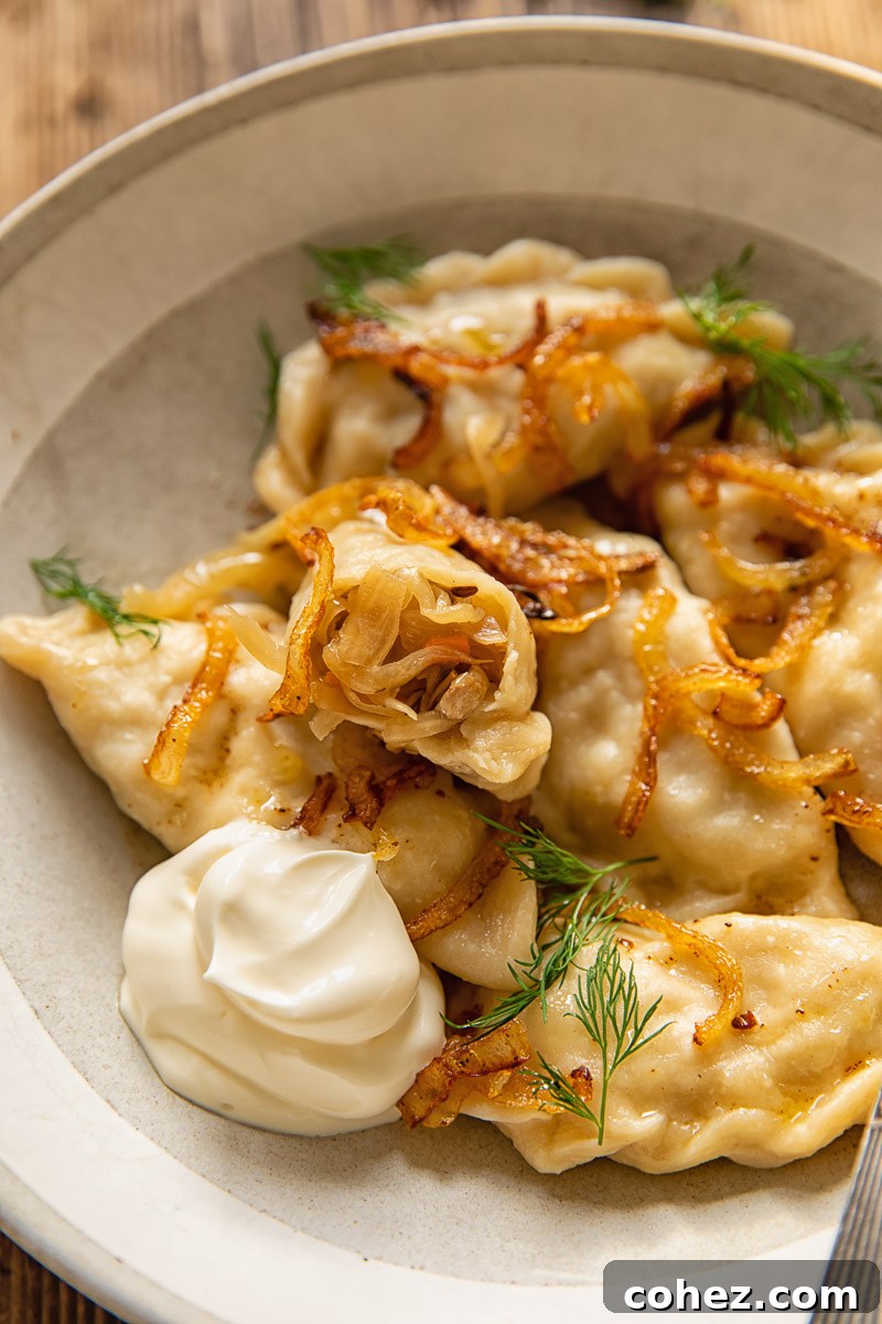 dumplings in a bowl, one of them showing the filling inside