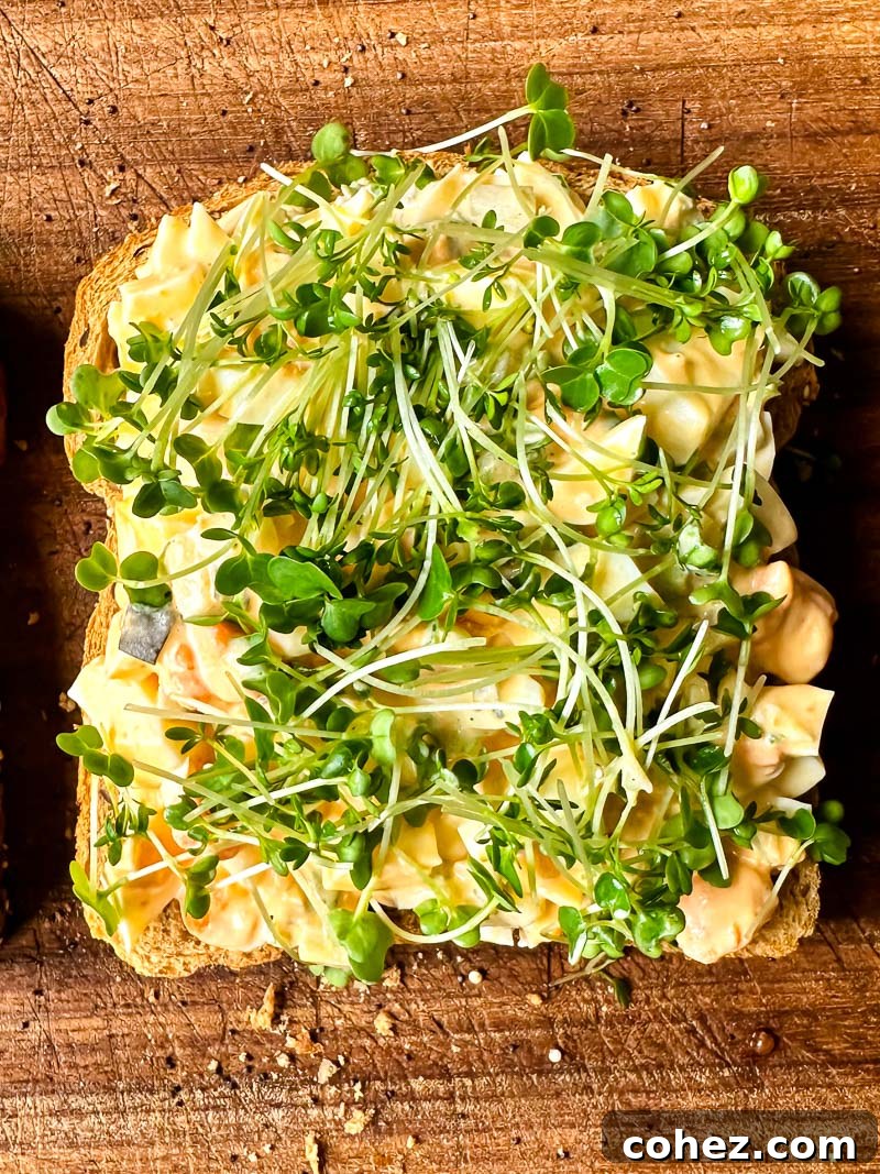top down view of egg salad and salad cress on top of a bread slice