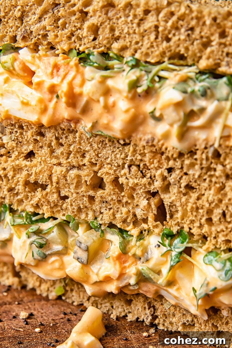 close up of egg mayonnaise sandwich cut in half