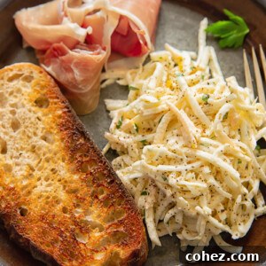 top down view of brown plate with celeriac remoulade, toasted bread slice and Parma ham slice