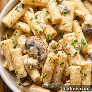 creamy pasta with mushrooms and sausage in a bowl