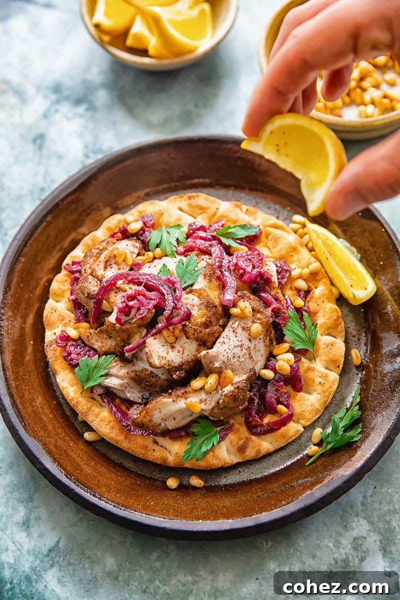Palestinian Sumac Chicken 6 Person squeezing lemon over Chicken Musakhan on flatbread for a fresh finish