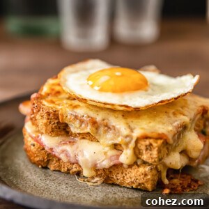 Ultimate Croque Madame 6 Side view of croque madame sandwich with egg on top on a plate