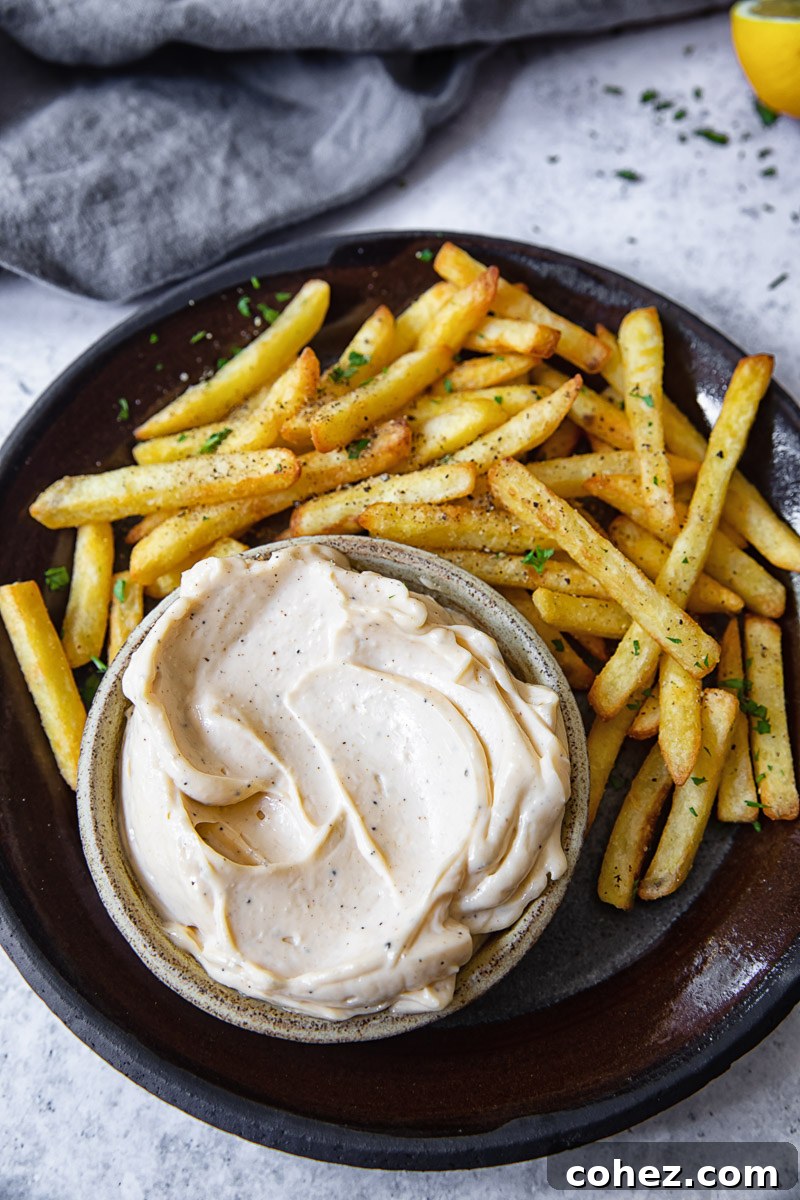 Decadent Truffle Aioli 4 Top down view of truffle aioli surrounded by fries on a plate
