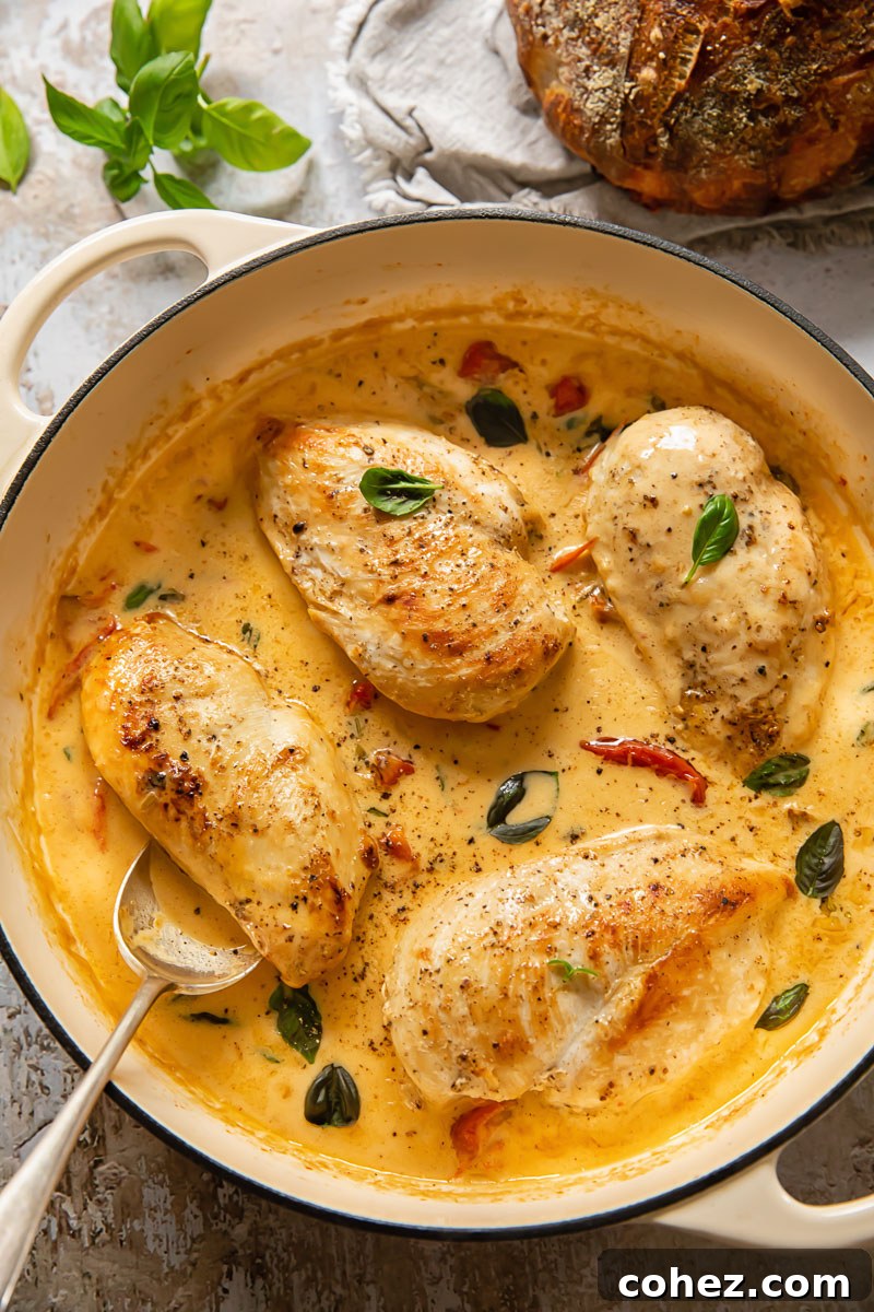 Top down view of marry me chicken with a spoon in a pan