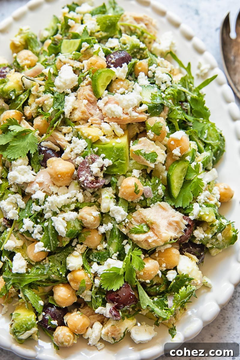 Plant-Powered Tuna Salad 3 Close up view of Chickpea Tuna Salad, highlighting the texture and fresh ingredients like avocado and crumbled feta, on an oval platter.