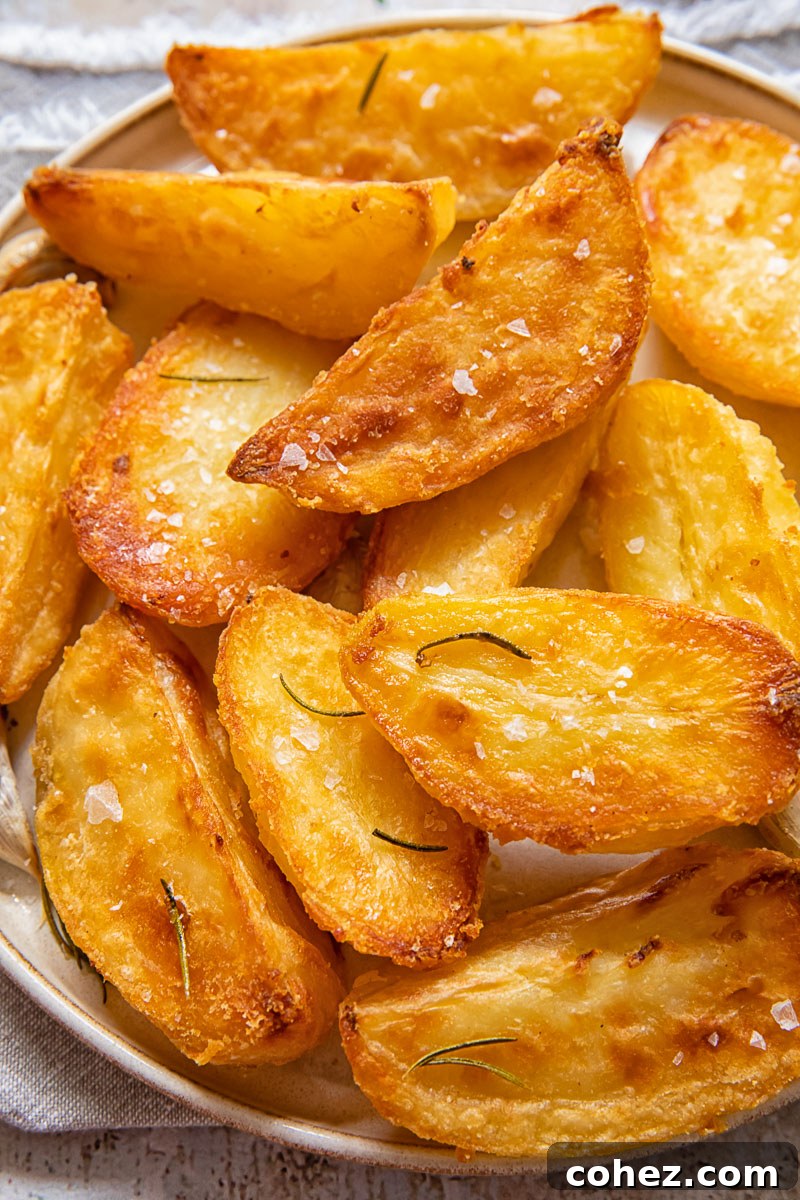 Top down view of roast potatoes on a white plate