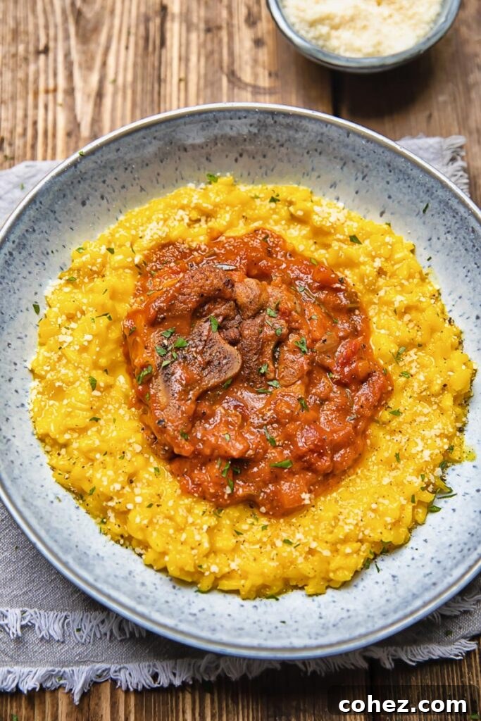 bowl of risotto with a red tomato and mushroom topping
