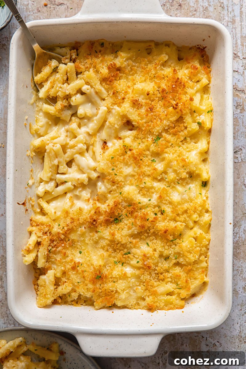Top down view of truffle mac and cheese in a baking dish, highlighting the golden-brown crust and bubbling cheese.