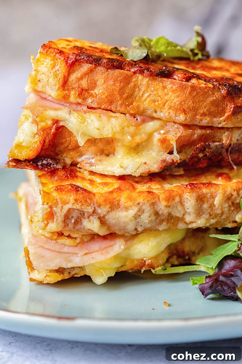 A perfectly golden Croque Monsieur sandwich, showcasing melted cheese and a crispy exterior