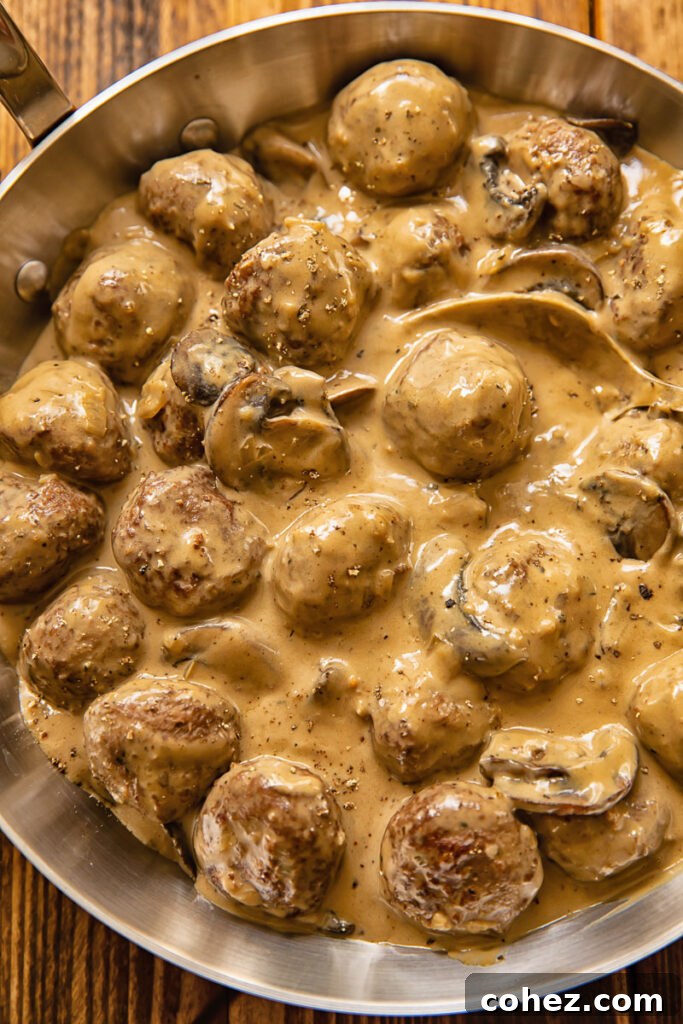 Top down view of meatballs in Marsala sauce in a pan
