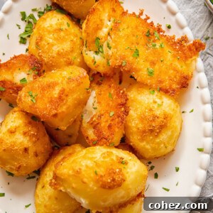 Close up shot of parmesan crusted potatoes, perfectly golden and crispy.