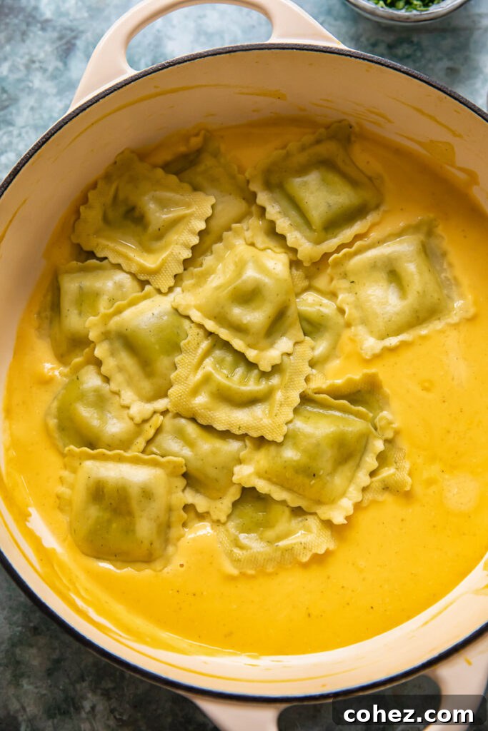ravioli parcels in pot on top of butternut squash ravioli sauce