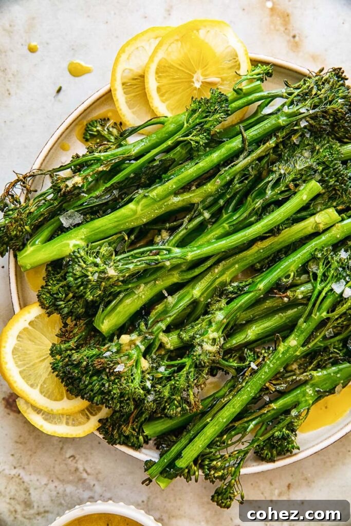 Plate of roasted Tenderstem broccoli garnished with lemon slices
