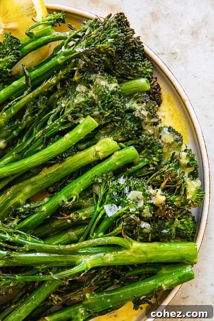 Close up of roasted Tenderstem broccoli with salt and lemon wedges