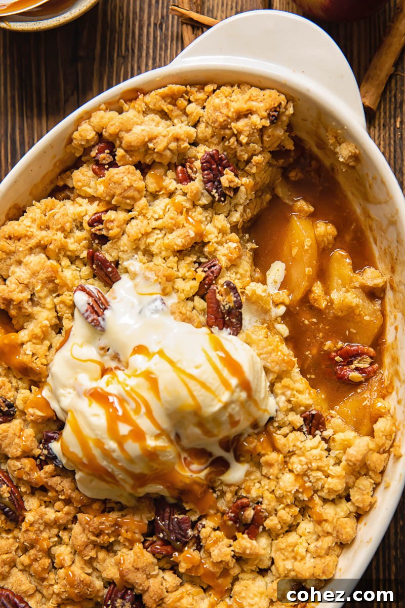 Top down shot of apple crisp with piece removed from baking dish