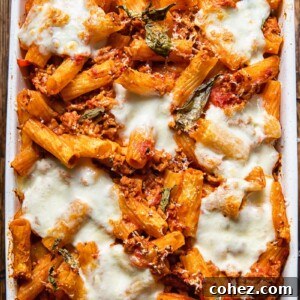 Top down view of pasta al forno topped with melted cheese is a baking dish