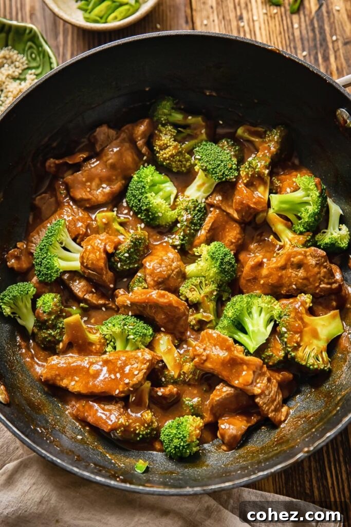 wok with beef and broccoli from the top down, showcasing tender beef and vibrant green broccoli in a rich sauce