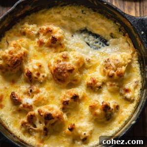 Close up shot of cauliflower florets in a pan with Mornay sauce.