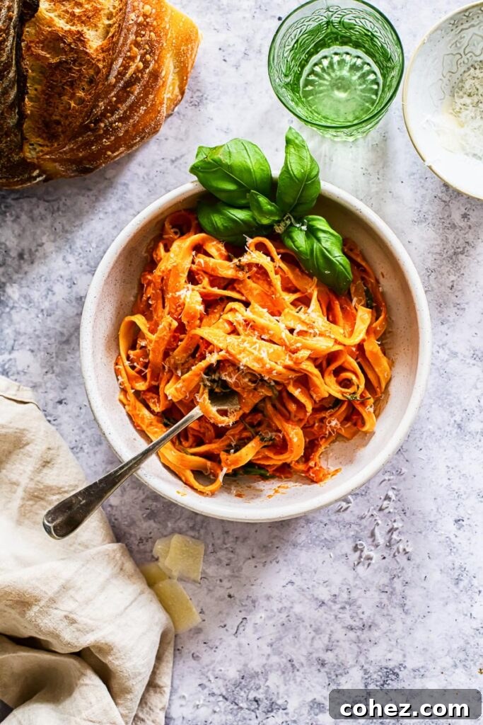 A beautifully presented bowl of creamy tomato mascarpone pasta, garnished and ready to eat