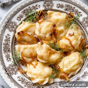 A bowl of golden potato vareniki topped with sautéed onions and fresh dill.