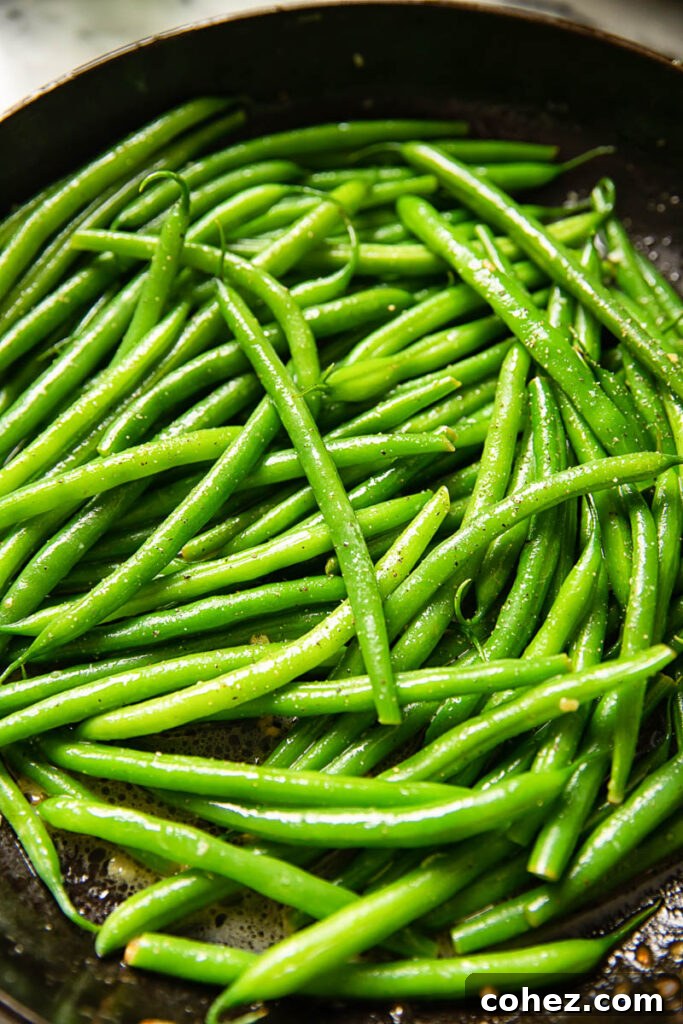 Close-up shot of vivid green beans, perfectly cooked and vibrant with color.