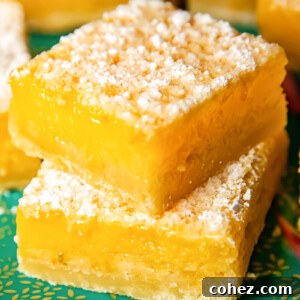 Zesty Lemon Squares 6 Close up shot of stacked lemon bars on a platter