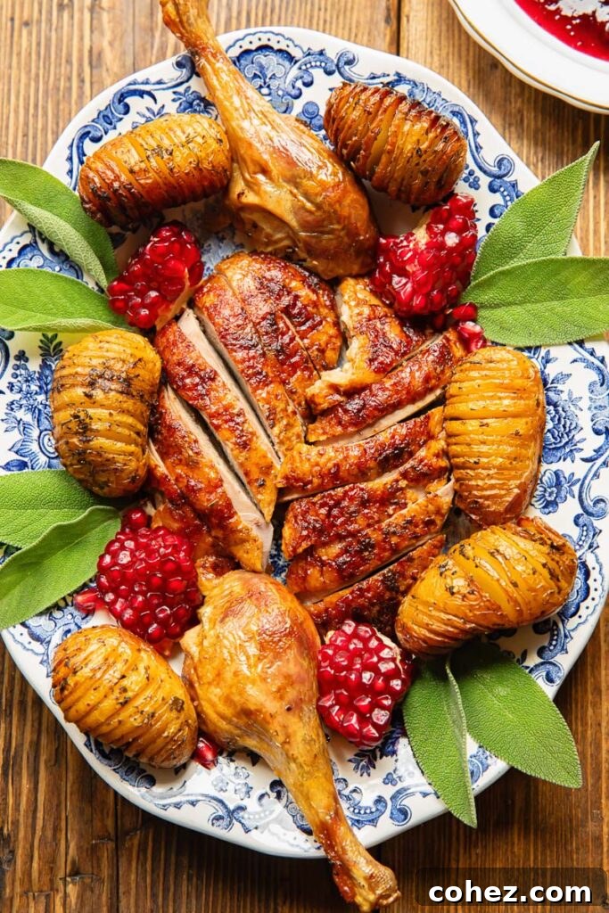 Regal Roast Duck with Port Cranberry Glaze 4 Top down view of slices of roast duck with potatoes on a plate