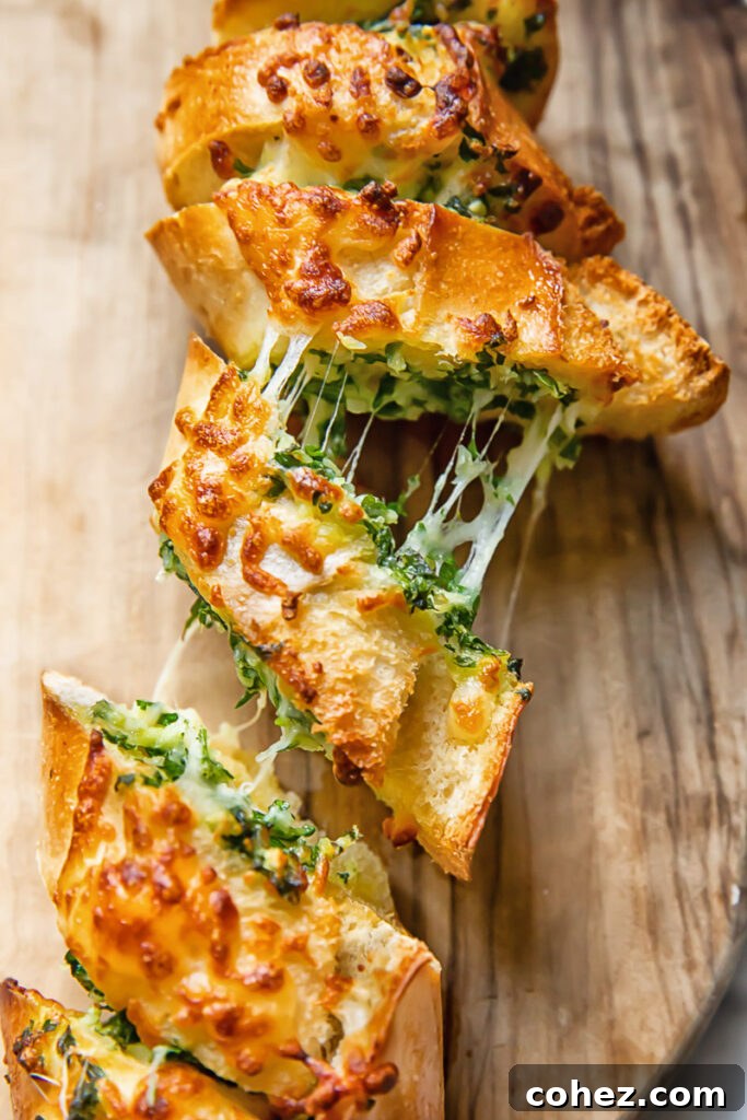 Close-up shot of melted mozzarella cheese stretching between two slices of freshly baked air fryer garlic bread.