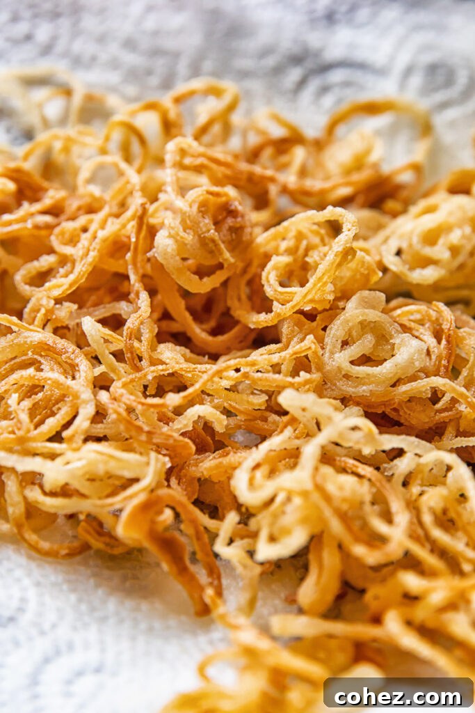 Close up shot of crispy caramelised onions stacked on top of each other on a towel