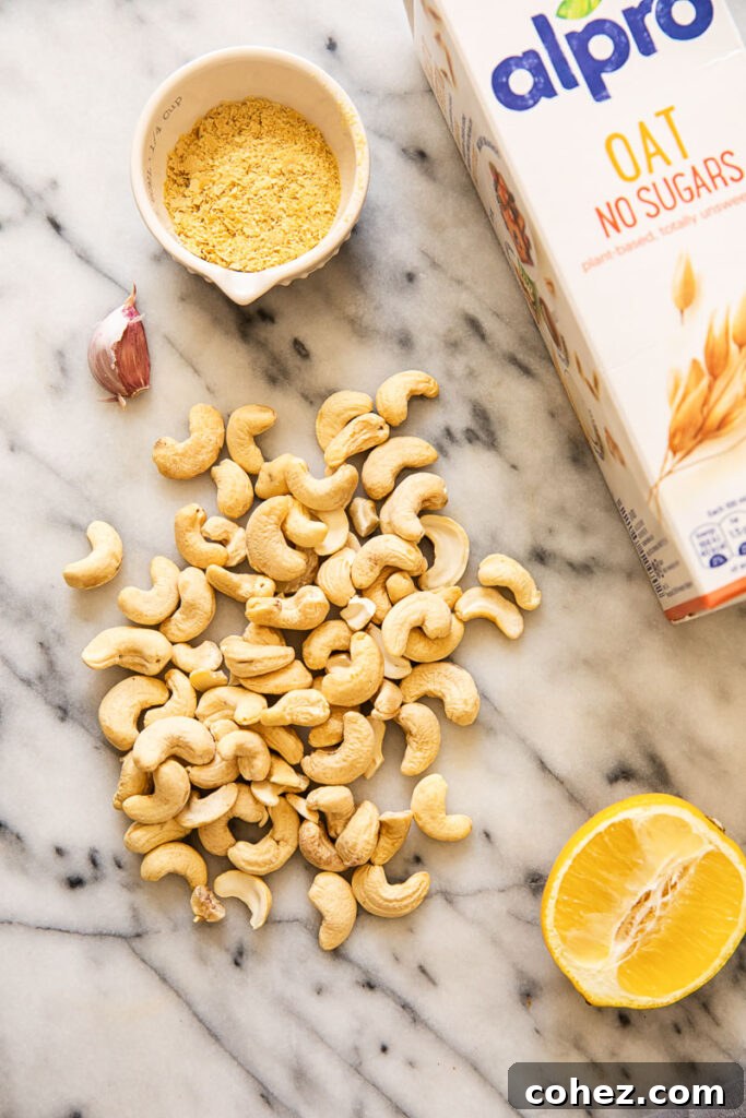 Cashews, lemon and oat milk carton on a marble surface