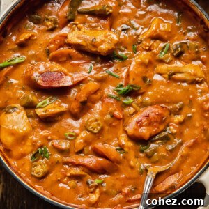 Chicken and sausage gumbo in a large pot with okra peppers and celery