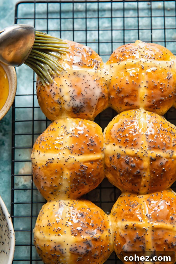 Sunshine Lemon Poppy Seed Hot Cross Buns 4 A brush applying a luscious lemon poppyseed glaze to freshly baked hot cross buns.