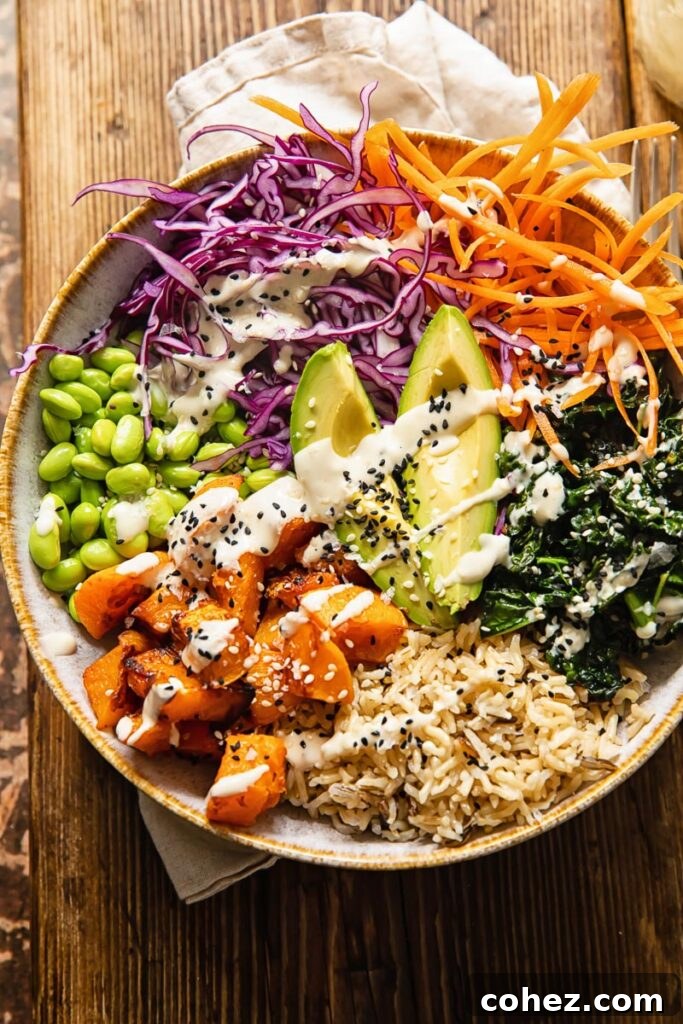 Vibrant Vegan Harvest Bowl 3 Close-up of a Buddha bowl with a generous drizzle of lemon tahini dressing, placed on a rustic wooden table.