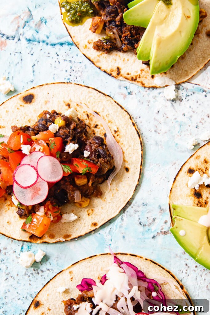 Black Bean Corn Tacos with Zesty Cilantro Lime Slaw 5 Black bean tacos with various toppings including avocado, slaw, and radishes