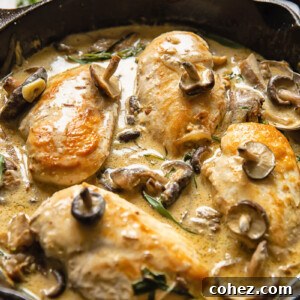 Side shot chicken breasts in forestiere sauce topped with mushrooms in a deep pan