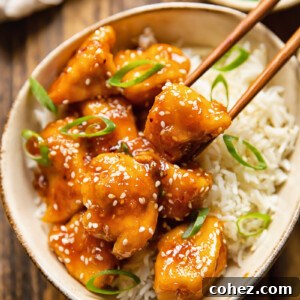 chopsticks removing piece of chicken from bowl of rice