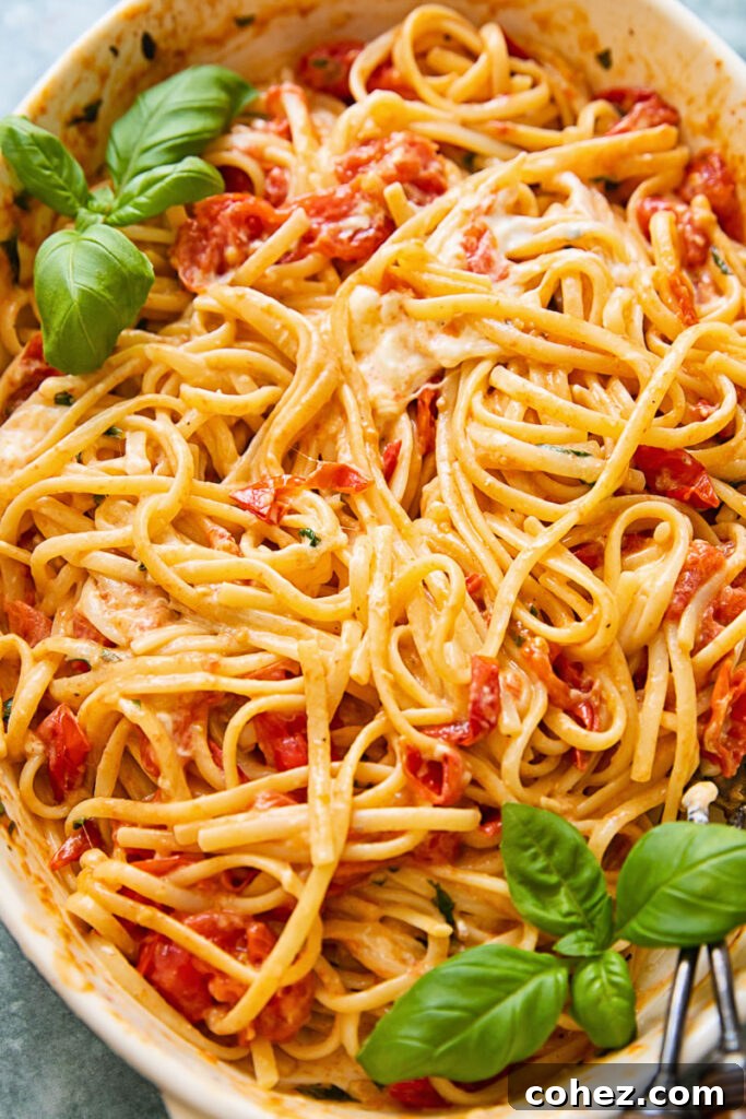 Burst Cherry Tomato Burrata Pasta 3 Cherry tomato pasta baking dish with melted mozzarella throughout, showcasing the rich sauce