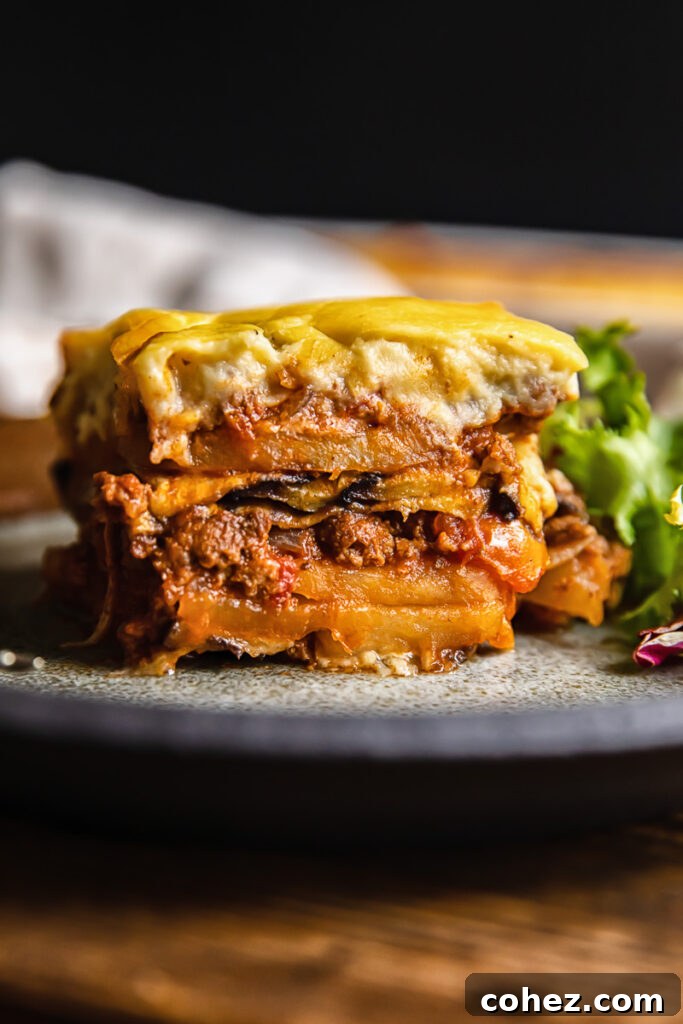 side view of a piece of moussaka on a plate