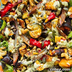Close up shot of roasted zucchini, pepper and eggplant topped with nuts and tahini dressing