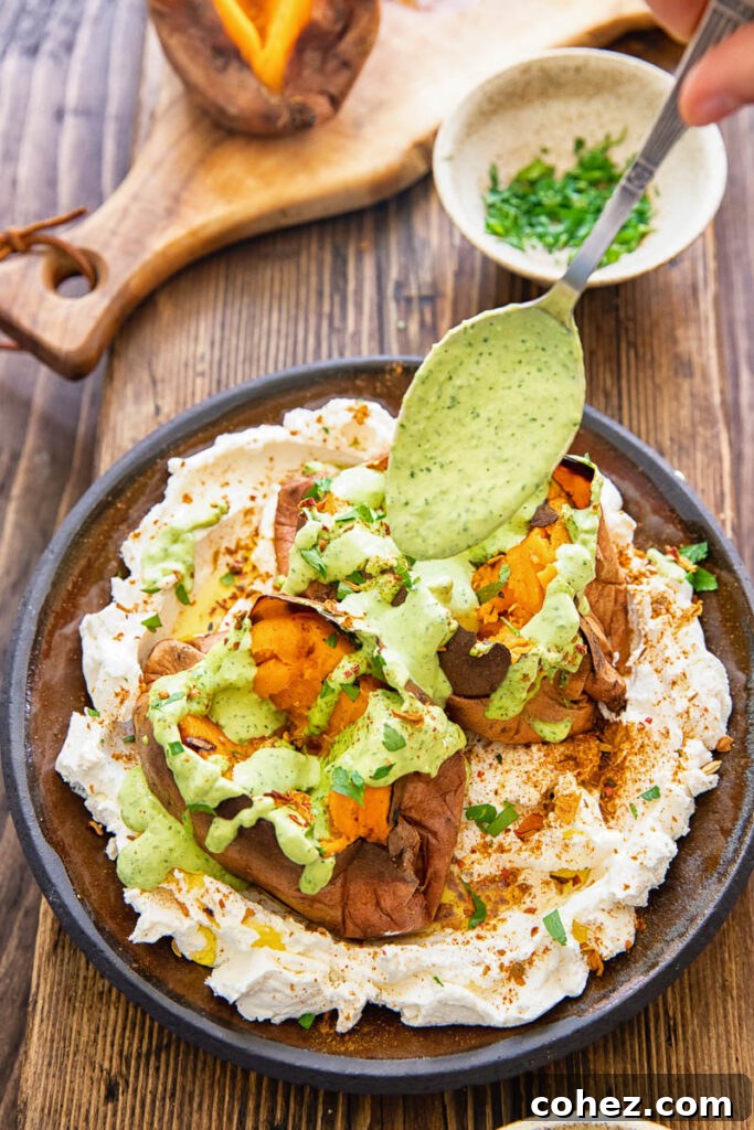 Roasted Sweet Potatoes with Creamy Garlic Tahini 5 spoon adding tahini sauce to roasted sweet potato