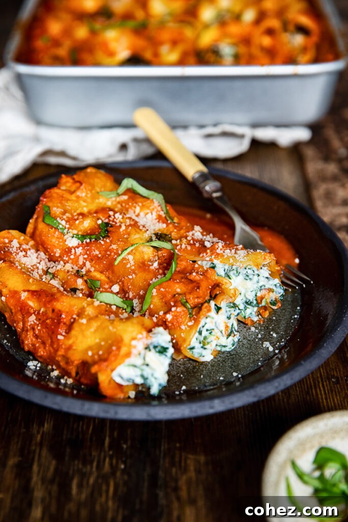 Plate of spinach and ricotta cannelloni on a wooden table