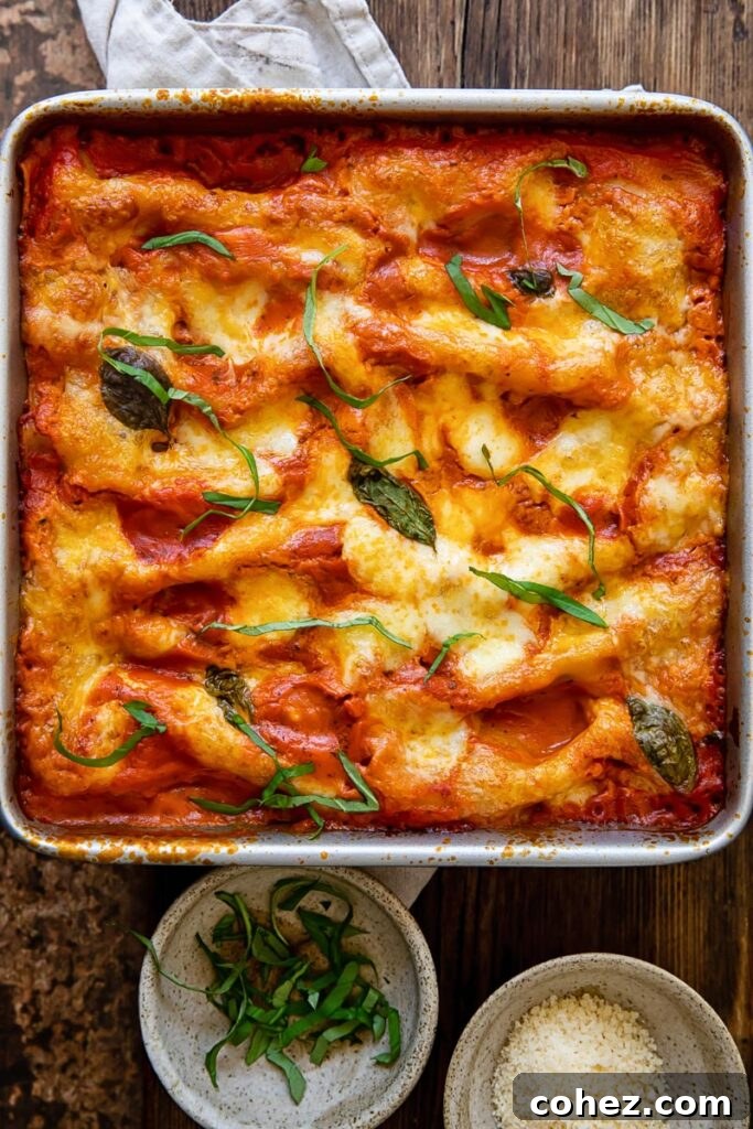 Top down view of spinach and ricotta cannelloni in a baking dish