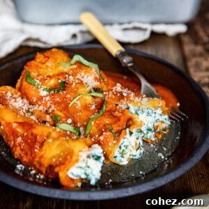 Plate of spinach and ricotta cannelloni on a wooden table