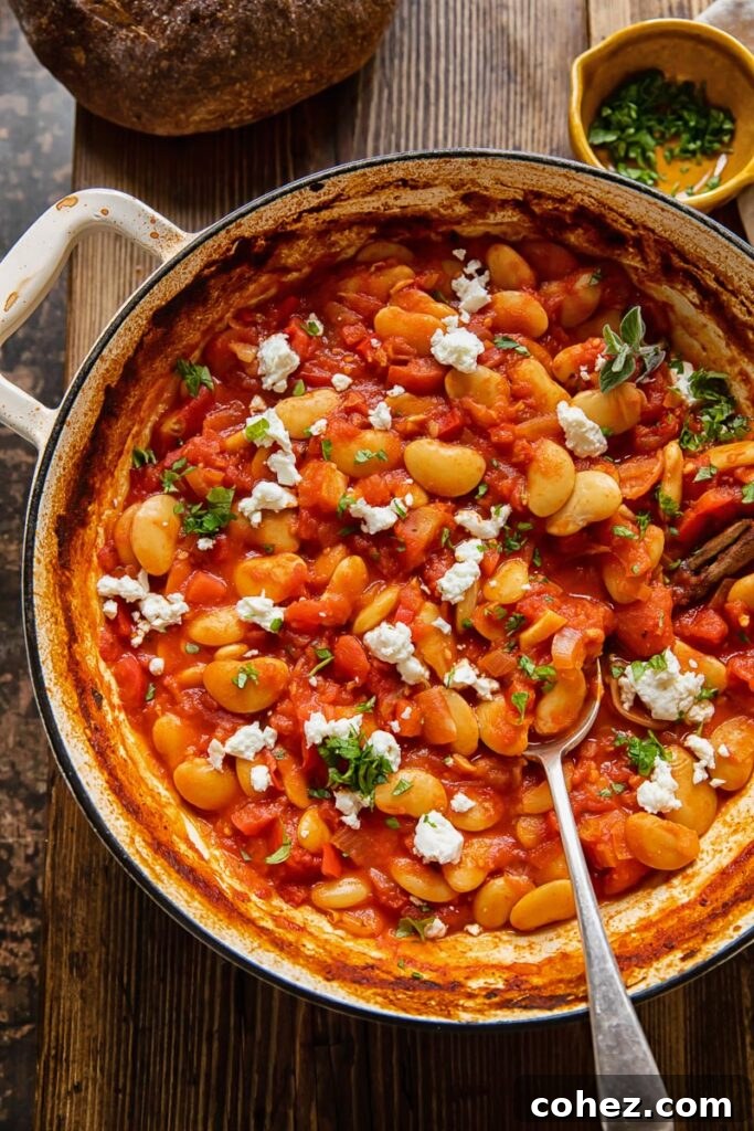Pan of butter bean stew in a pot with spoon